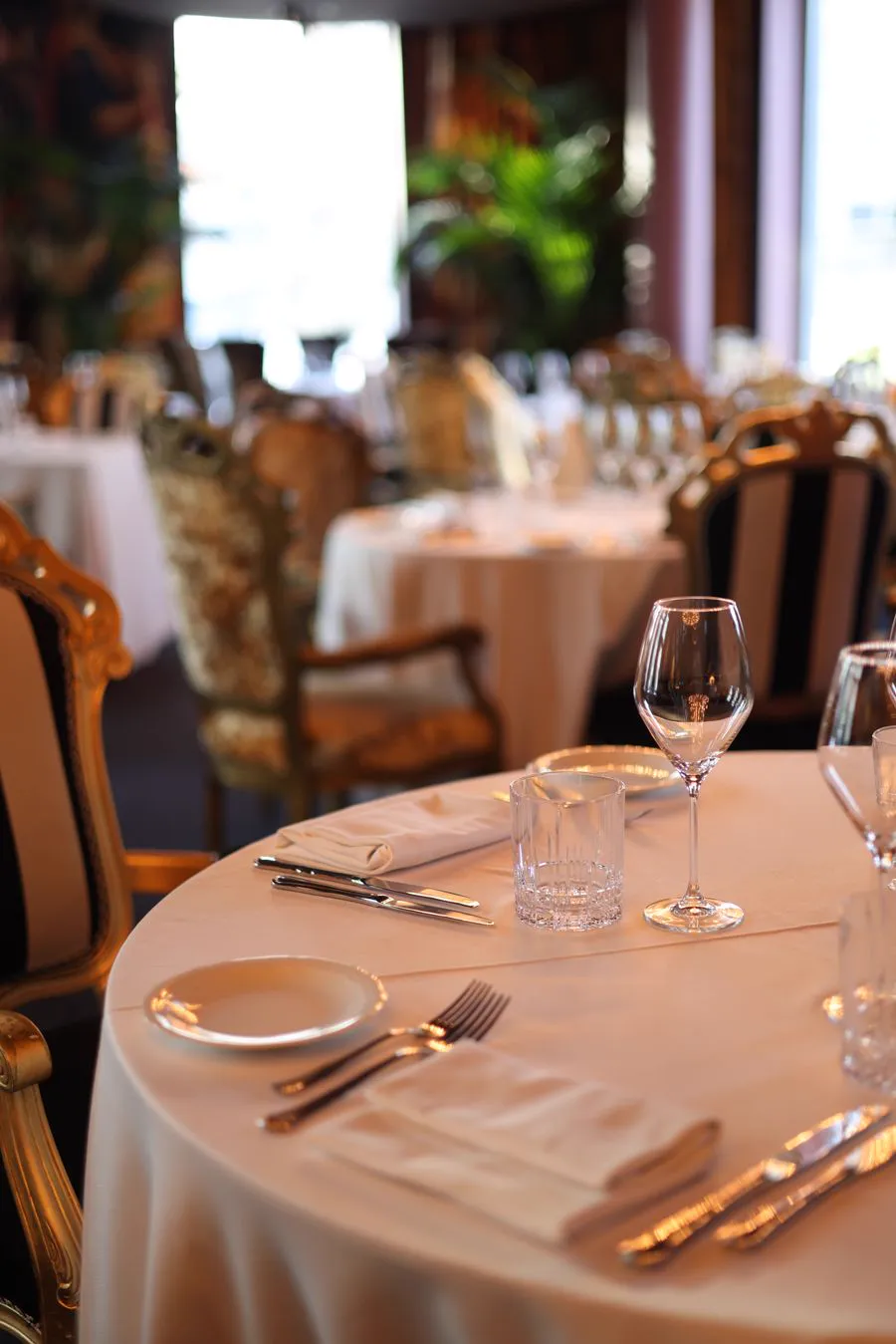 Upscale dining room with elegantly set tables and warm lighting